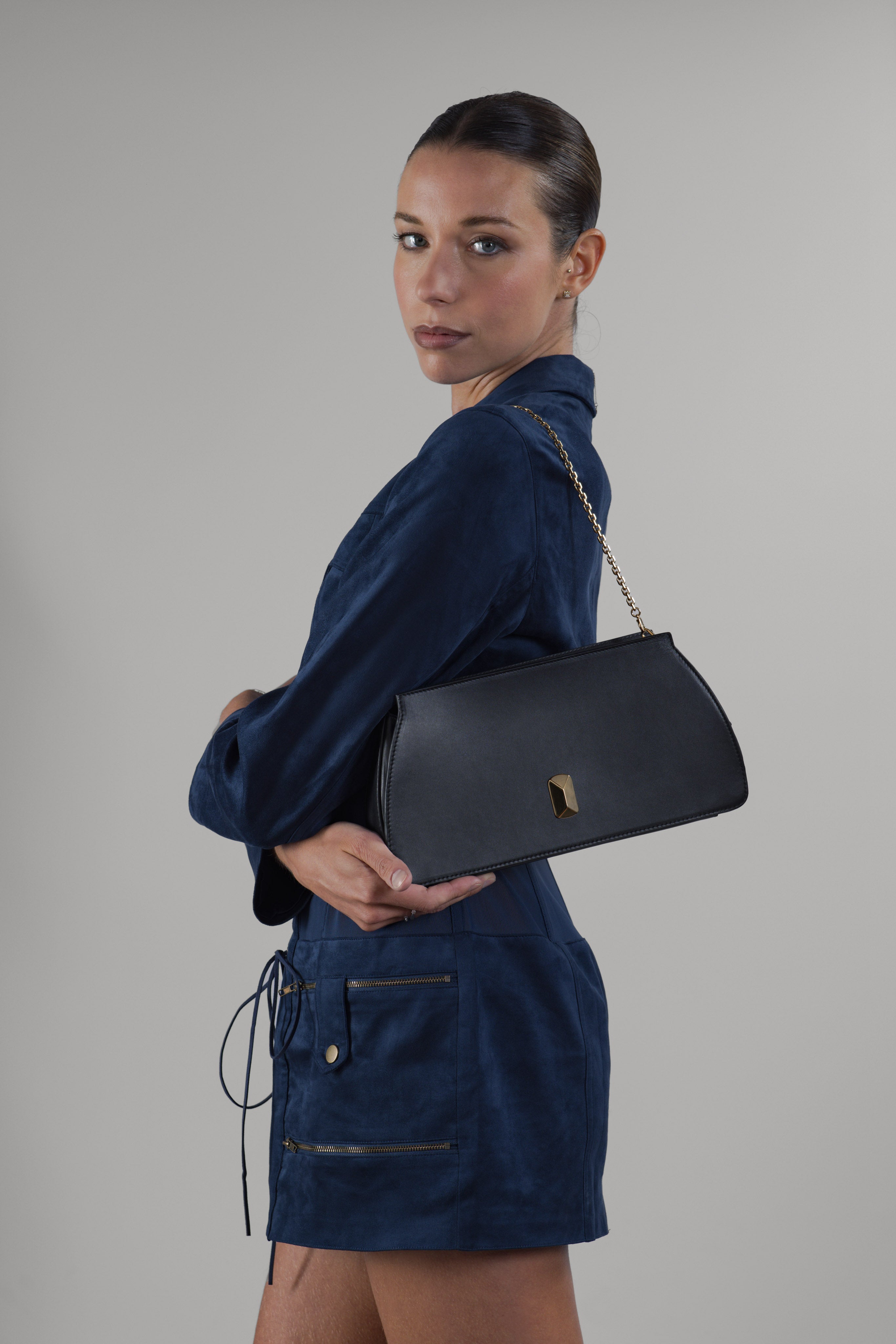 Woman wearing No. 15 Convertible Clutch in black leather
