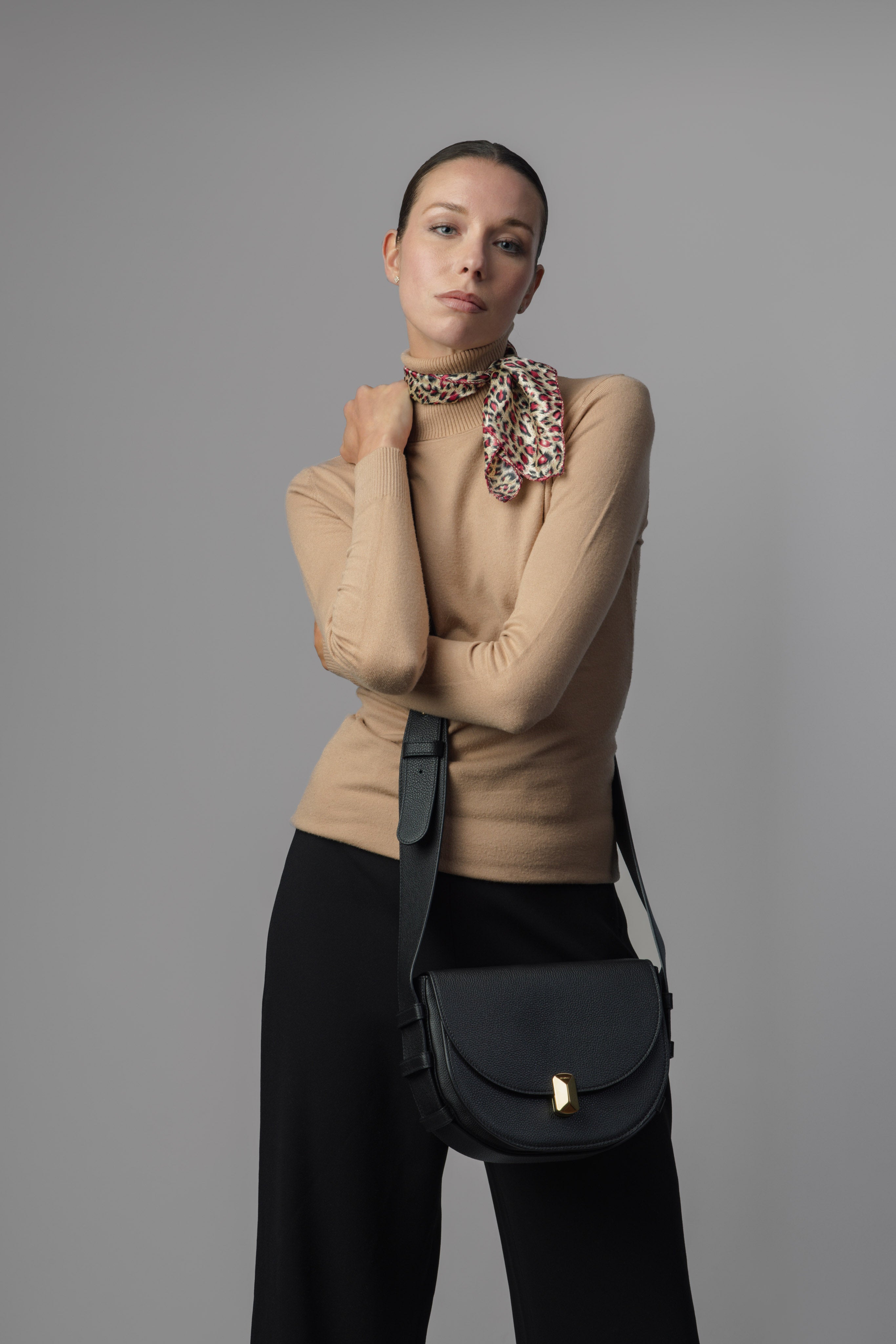 Woman carrying No. 18 black Italian leather crossbody bag
