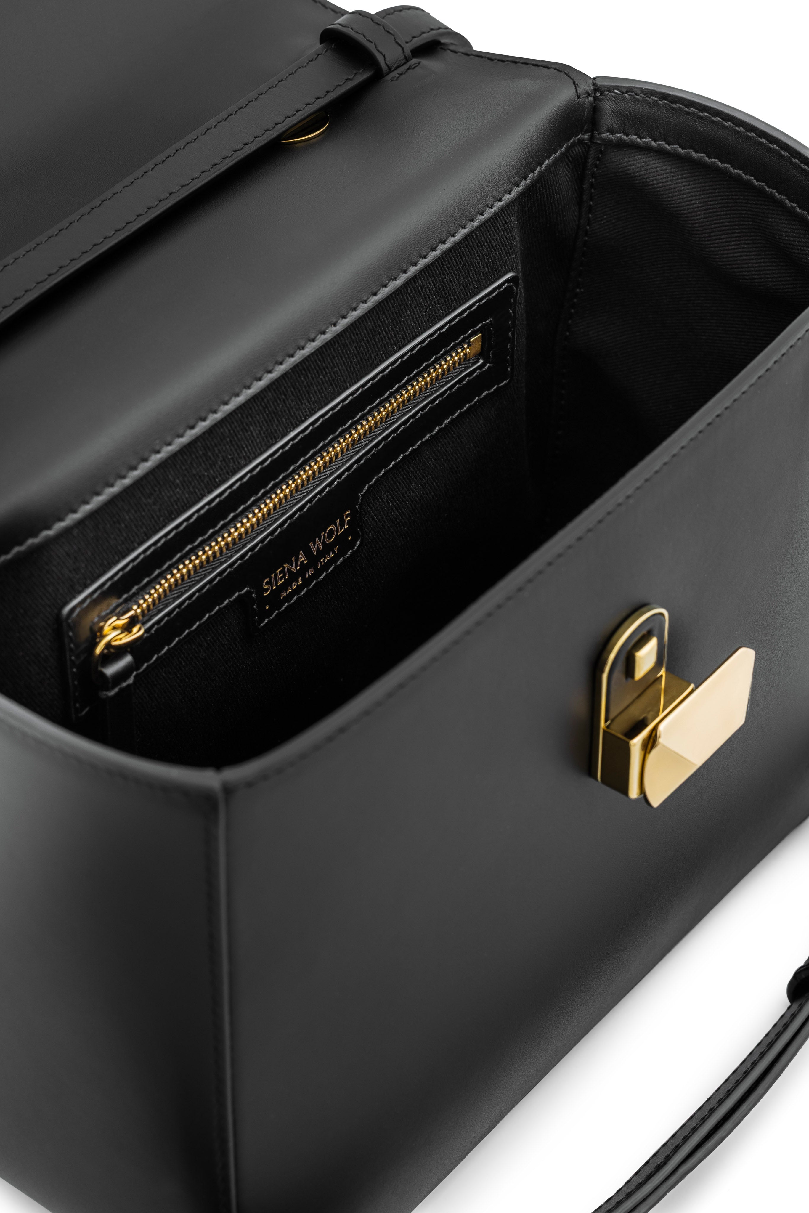 Side view of No. 16 classic top handle bag showing elegant silhouette and interior
